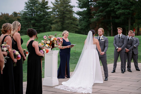 Image of bride and groom during weddingg ceremony at the outdoor space at the Cape Club of Sharon.