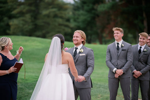 Image of bride and groom during weddingg ceremony at the outdoor space at the Cape Club of Sharon.