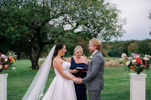 Image of bride and groom during weddingg ceremony at the outdoor space at the Cape Club of Sharon.