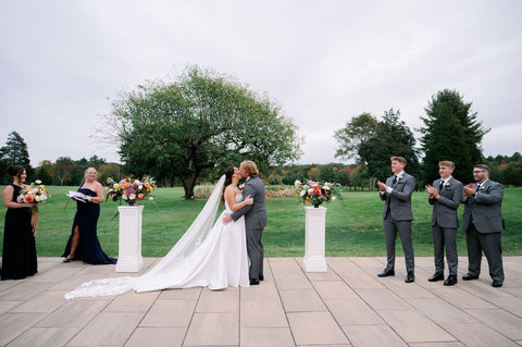 Image of bride and groom during weddingg ceremony at the outdoor space at the Cape Club of Sharon.