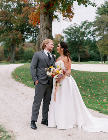 Image of bride and groom during wedding portraits at the outdooe space at the Cape Club of Sharon.