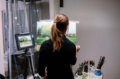 Image of Devin Tormey Art, Boston wedding painter, doing a live wedding painting of the ceremony during the cocktail hour.