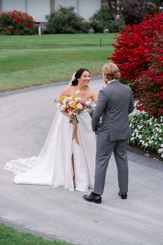 Image of bride and groom during first look.