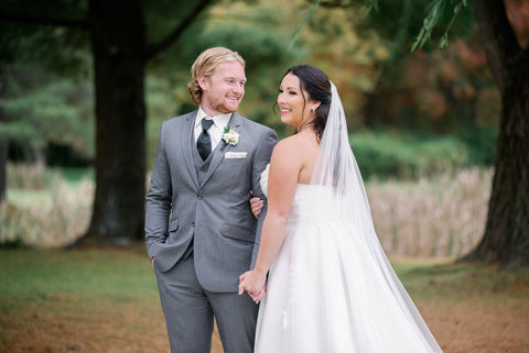 Image of bride and groom taking couples portraits outdoors at the Cape Club of Sharon, a Massachusetts wedding venue.