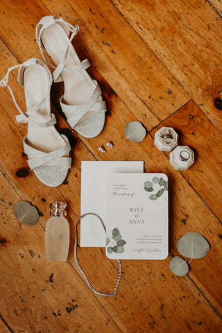Image of wedding invitatioon and bride's accessories for a rustice elegant wedding