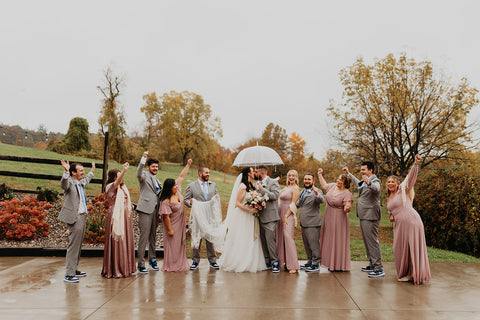 Image of wedding party at Westfield River Brewing Company. The grommsmen are in gray suits and the bridesmaids are in long pink dresses.