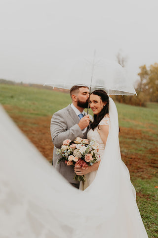 Wedding portrait of bride and groom. The bride is holding her bridal bouquet.