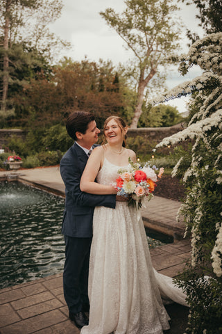 wedding portrait of bride and groom at Harding Allen Estate in MA, colorful bridal bouquet with Peonies, gerberas, snapdragons, poppies, roses, ranunculus, chamomile, delphinium, craspedia, alstroemeria, hypericum, solidago, roses, stock, larkspur, wildflowers 