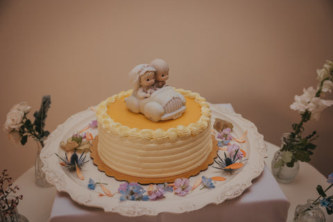 Wedding cake with wildflowers decorating the cake table