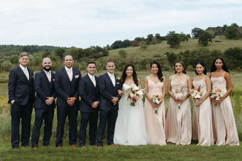 Bridal party photos: bouquets with timeless flowers and modern foliage including roses, dahlias, delphinium, dyed grevillea, rice flower, cress, and thistle