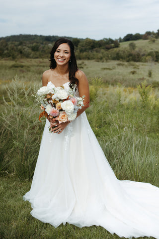 summer wedding bridal bouquet with timeless flowers and modern foliage including roses, dahlias, delphinium, dyed grevillea, rice flower, cress, and thistle