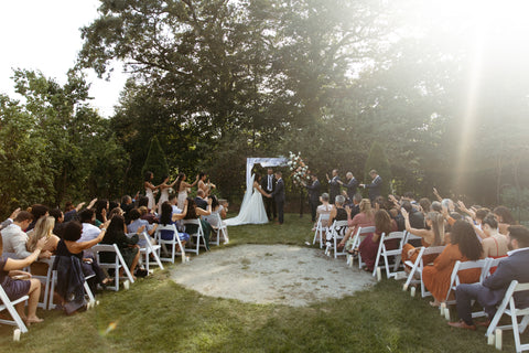 late summer floral wedding arbor with timeless flowers and modern foliage including roses, dahlias, delphinium, dyed grevillea, rice flower, cress, and thistle