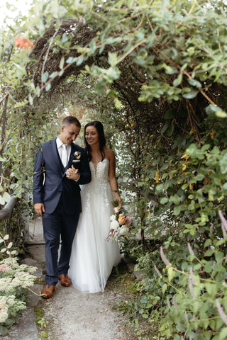 Wedding couple at the Herb Lyceum late summer floral wedding bridal bouquet with timeless flowers and modern foliage including roses, dahlias, delphinium, dyed grevillea, rice flower, cress, and thistle