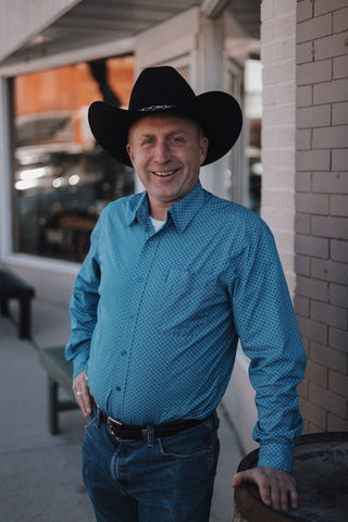 Owner Andrew picture in cowboy hat