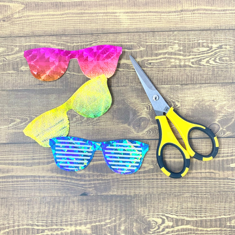 Three rainbow foiled paper sunglasses with scissors