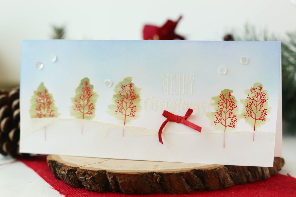 Christmas card with stamped and watercolored Christmas trees.