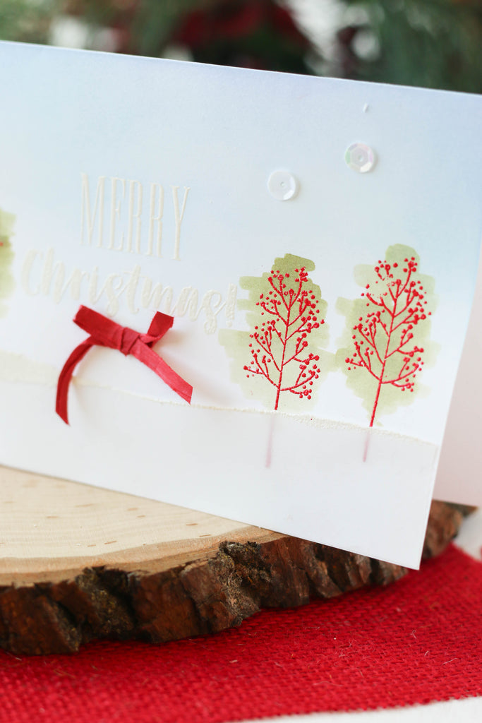 Christmas card with stamped and watercolored Christmas trees.