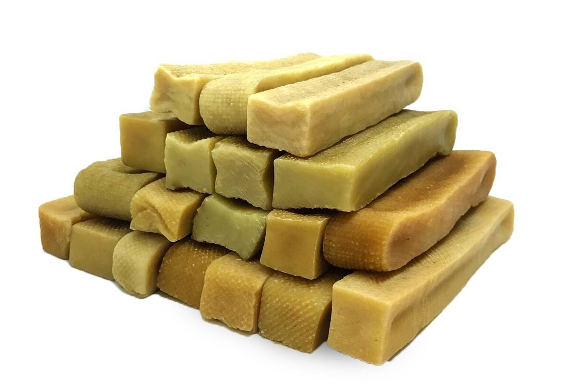 A stack of natural beige soap bars on white background.