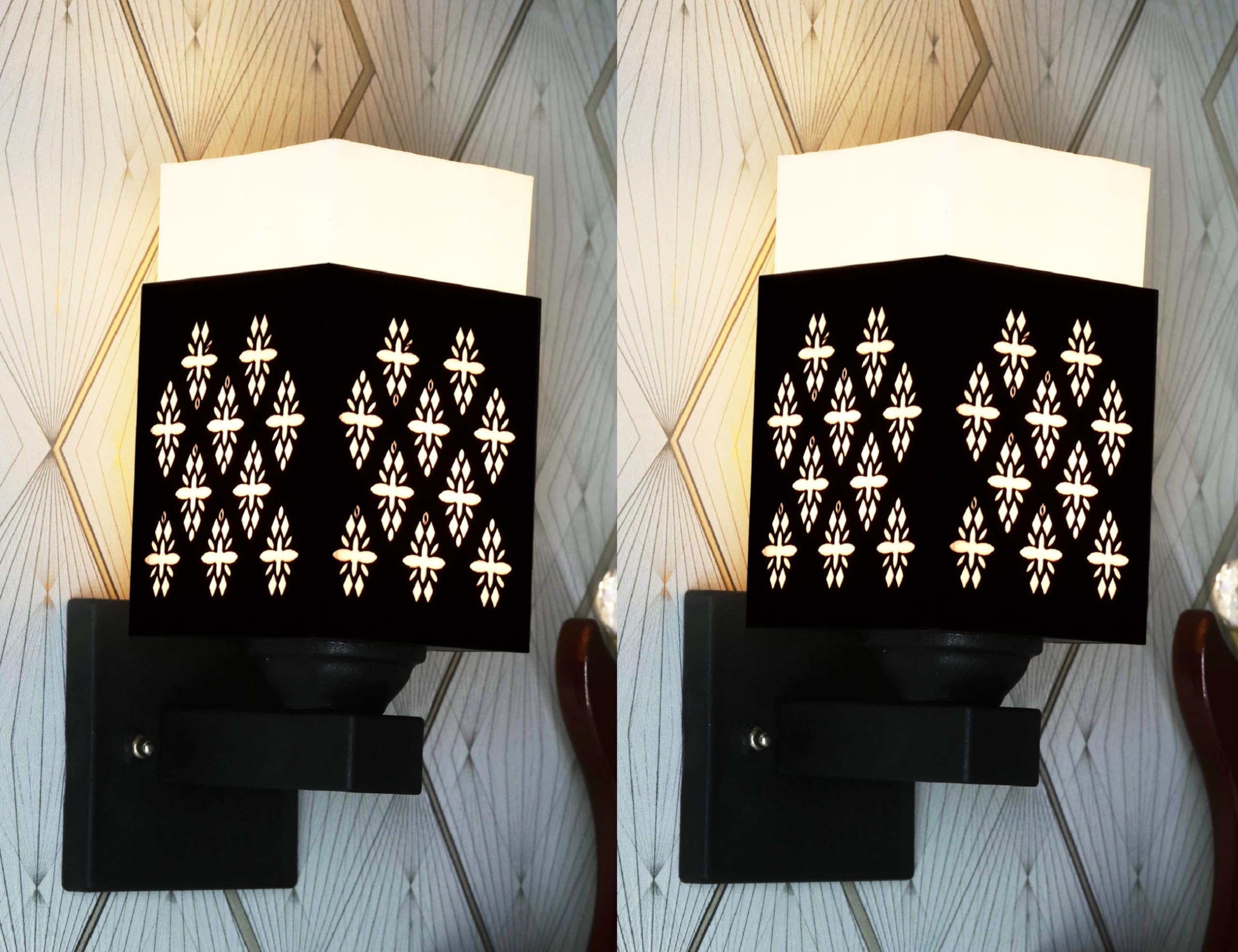 A wall-mounted light fixture with a decorative black lampshade emitting a soft, warm glow.