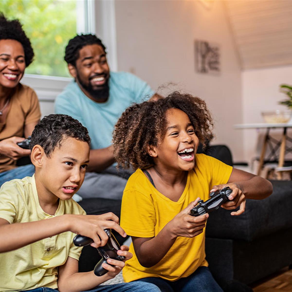 A family enjoys playing video games together in their living room.