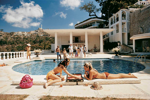 Slim Aarons photograph of two women playing backgammon by the pool