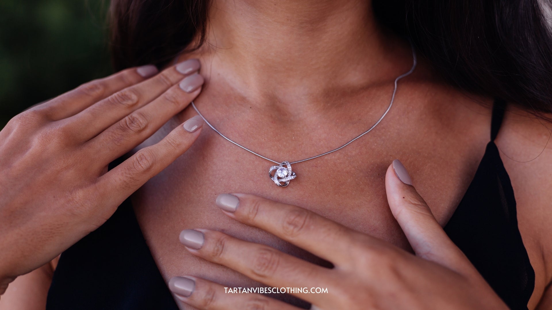 Outdoor portrait of woman in black dress with silver Celtic Love Knot Jewelry