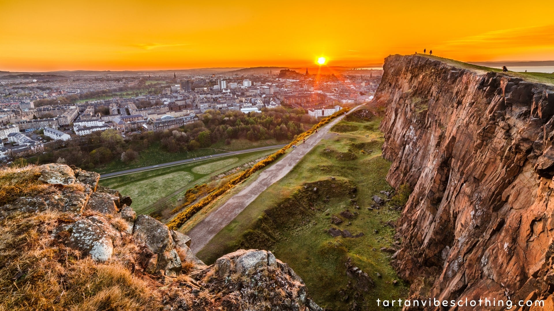 View of Edinburgh and Edinburgh castle from Arthur's Seat peak at sunset