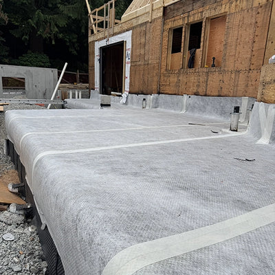 Taping the seams of SUPERSEAL Double Drain with SUPERSEAL Waterproofing Tape