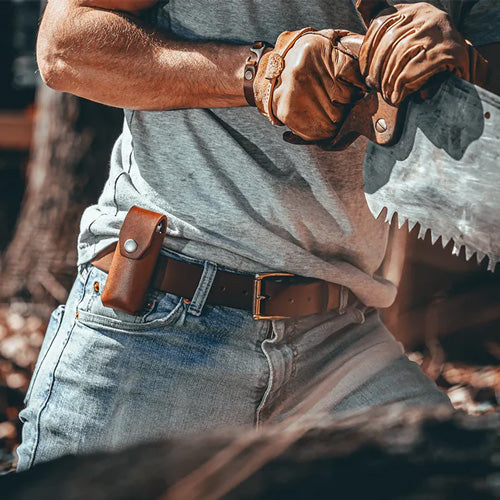 man wearing leather belt and sheath and working on wood