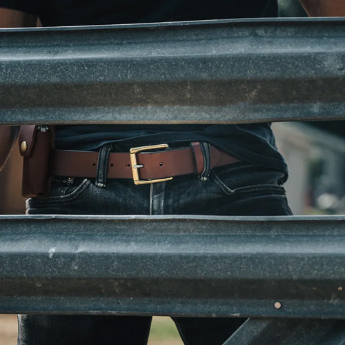 man wearing leather belt and sheath