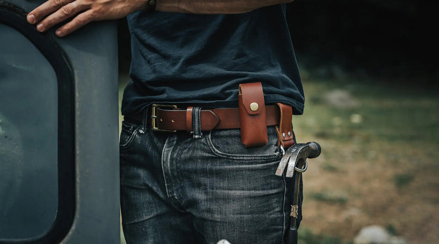 man sports leather belt with sheath, and hammer holster