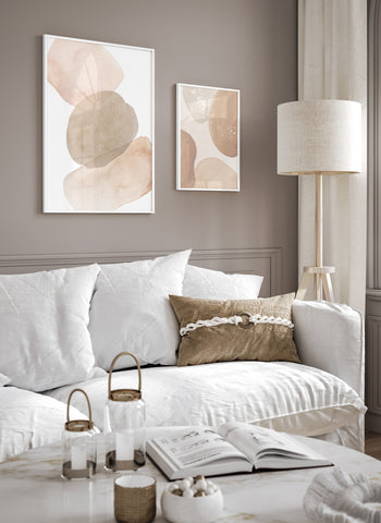 Set of 2 neutral tones abstract wall art in white frames styled in a neutral and white living room. 