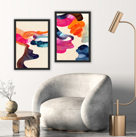 Colourful set of 2 abstract wall art with blue, red and orange framed in a black frame and pictured in a grey and neutral living room. 