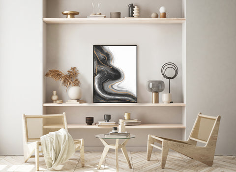 large black and white abstract wall art in black frame pictured in a neutral living space. 
