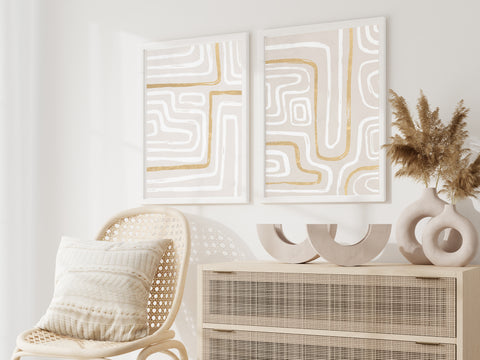 Set of 2 gold and white line abstract wall art pictured in a neutral bedroom. 