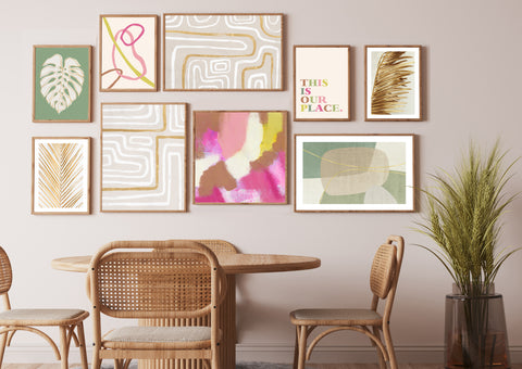 Colourful gallery wall with botanical, line and boho styles pictured in a neutral and wood dining room. 