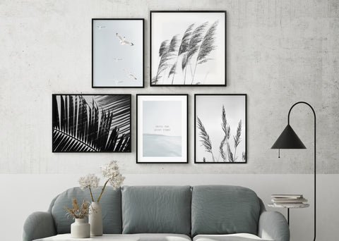 Black and white photography wall art gallery wall in a grey and black living room. 