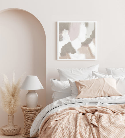 Neutral toned abstract wall art in white frame pictured in neutral bedroom. 