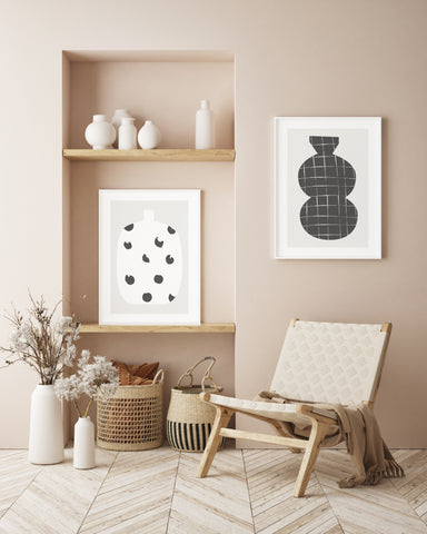 Abstract black and white vases wall art set in a neutral living space.