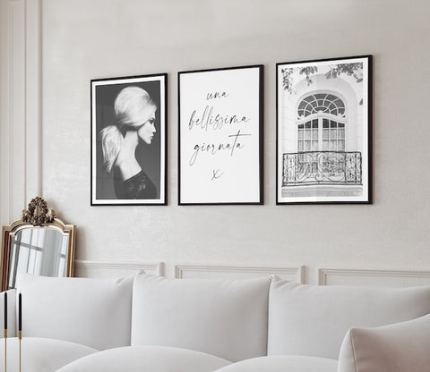 black and white graphic art gallery wall pictured in a white and neutral living room. 