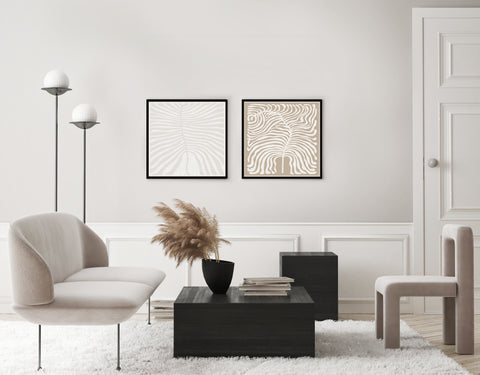Set of 2 neutral abstract wall art in a neutral and black toned living room. 