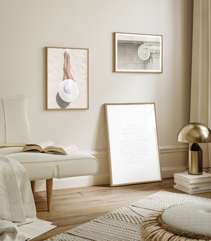 Neutral framed prints displayed in a neutral bedroom 