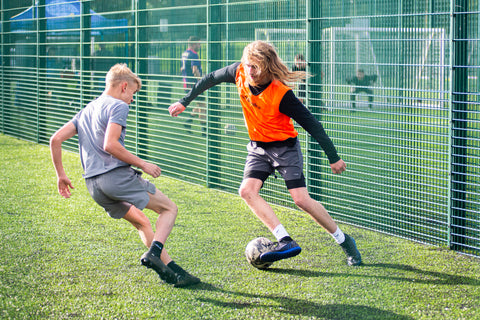 Co-Founder Liam Bedford takes on a defender in Charity Football Tournament.