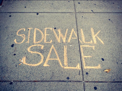 Sidewalk sale written in chalk
