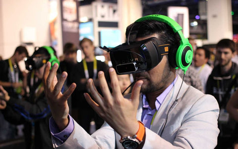 a man looking at his hands wearing a VR headset