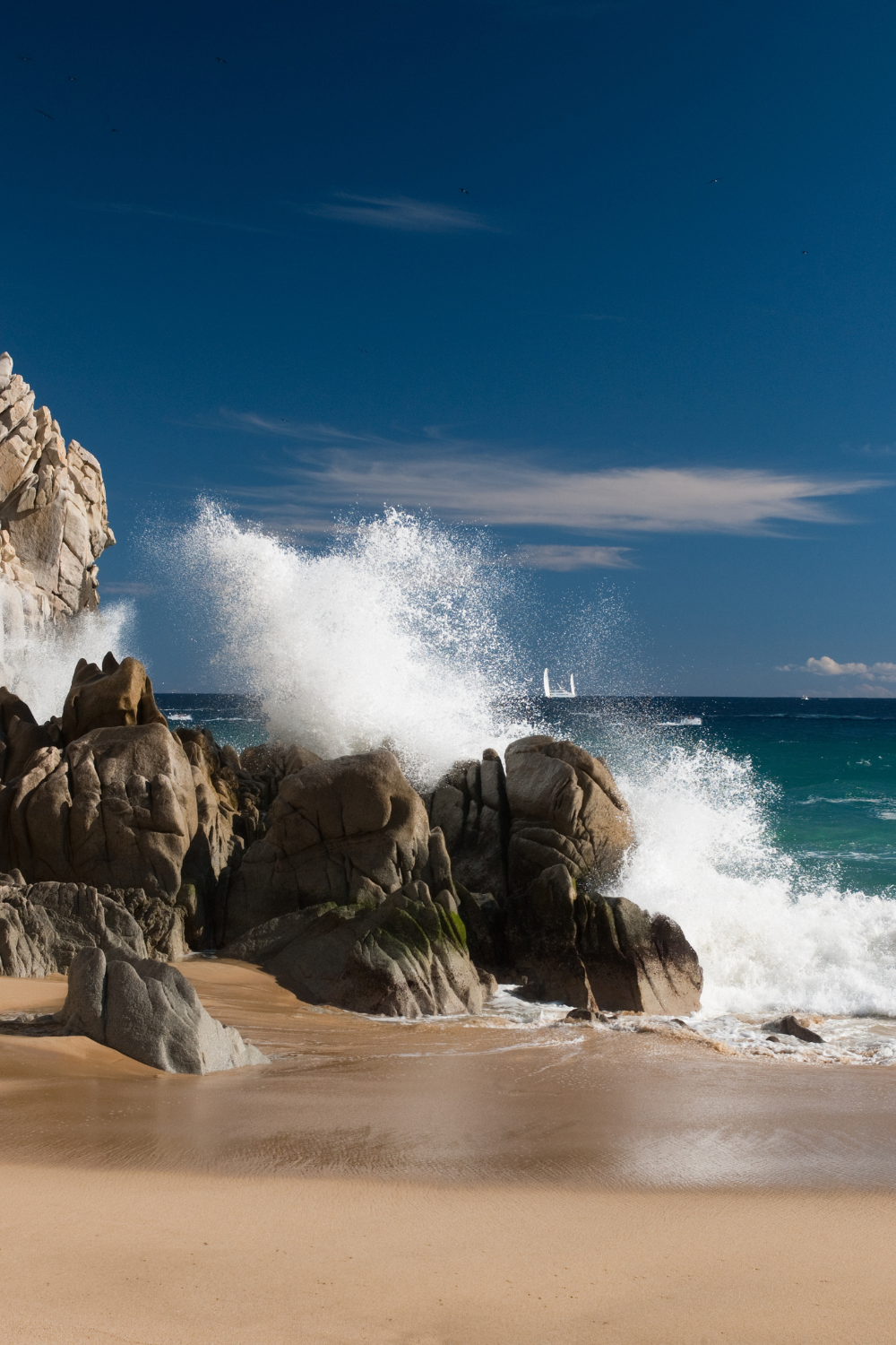Waves crashing into rocks on beach shore