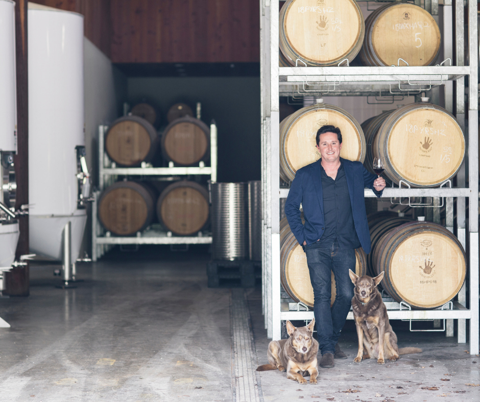 Winemaker with wine and dog