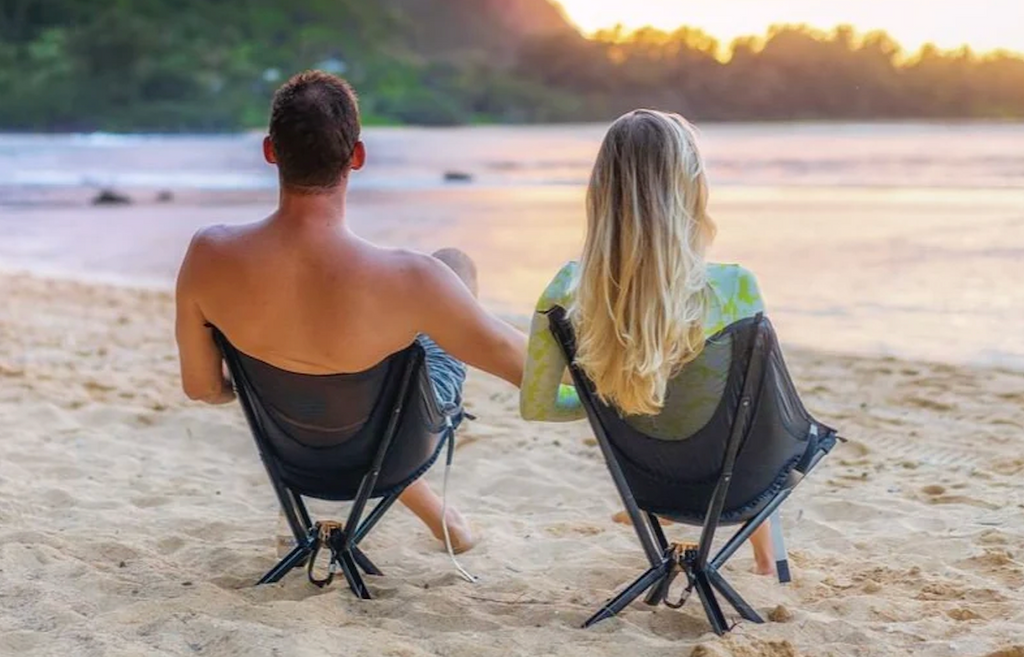 A couple watching the sunset in their Cliq foldable camp chairs