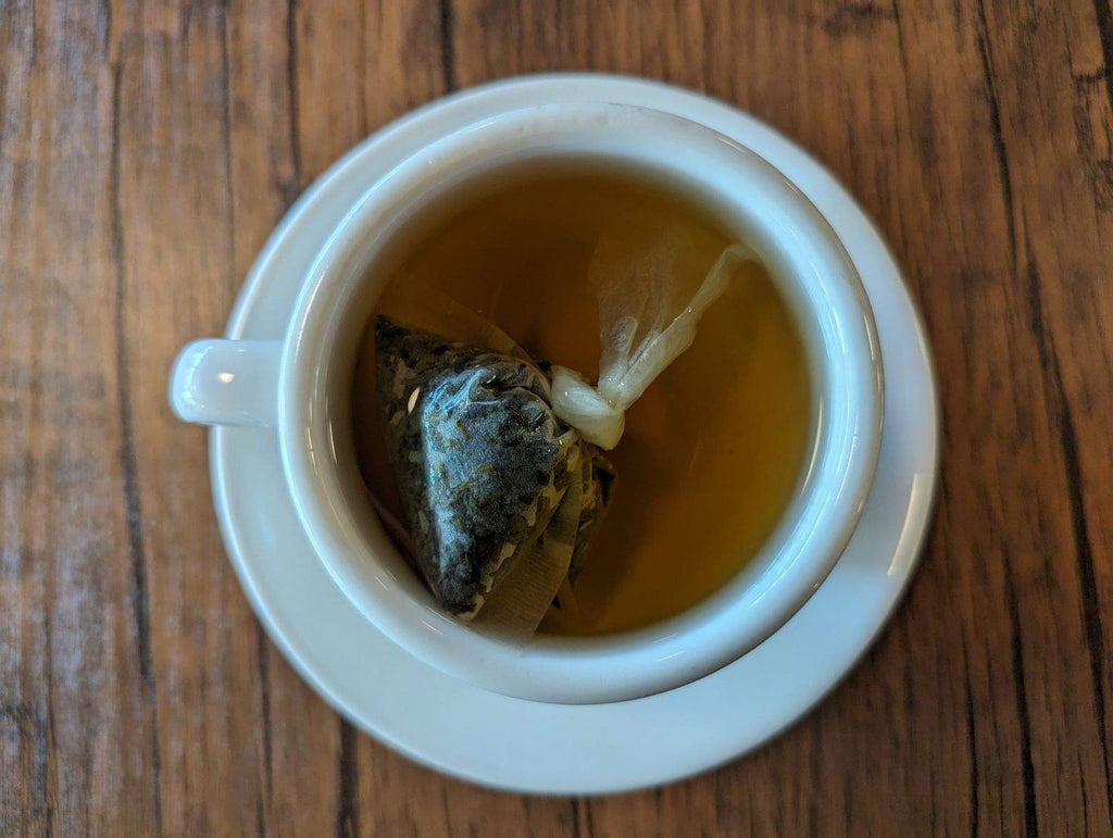 Loose leaf sencha green tea bag in a mug
