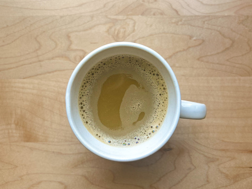 A cup of brewed hojicha latte